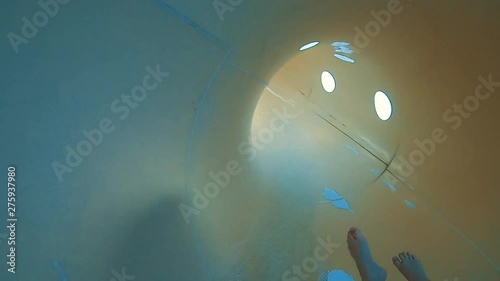 Amusement park, water park, water slide.  Girls roll with yellow and blue water slides. Personal Perspective of a Girl Speeding Down at Water Slide. Fun on the water slide in aquapark.