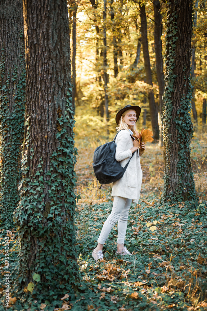 Female autumn fashion concept. Woman happy autumn. Autumn and leaf fall Dreams. Autumn time for Fashion. Portrait of beautiful woman walking outdoors.