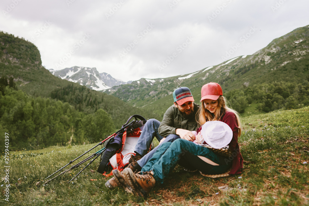 Fototapeta premium Happy family hiking with baby in mountains travel vacation outdoor mother and father parents lifestyle summer trip together