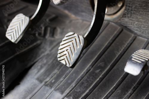 Three driving pedal with a manual transmission. Pedals in the car. Manual gearbox. Black three pedals in the car