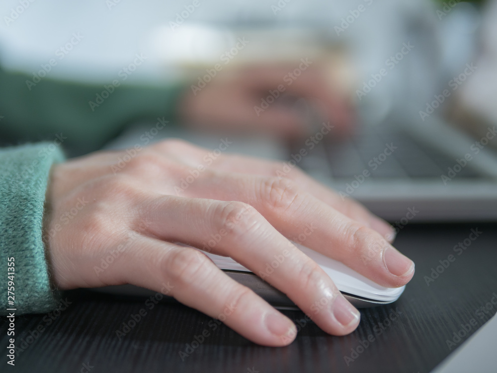Girl hand using wireless mouse for laptop at home. Girl hand using wireless mouse for laptop at home.