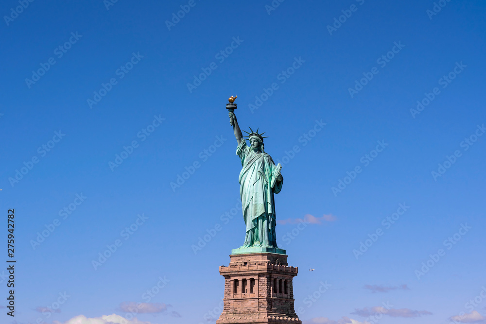 The Statue of Liberty under the blue sky background, Lower Manhattan, New York City, Architecture and building with tourist concept