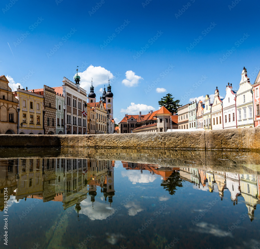 Fototapeta premium Main square of Telc city, a UNESCO World Heritage Site, on a sunny day with blue sky and clouds, South Moravia, Czech Republic.
