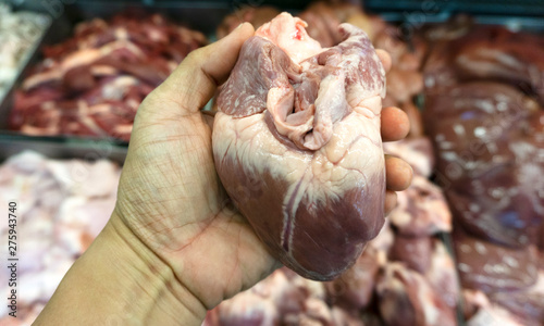 Pig heart in hand at the fresh market, Ingredients for cooking. food concept. .