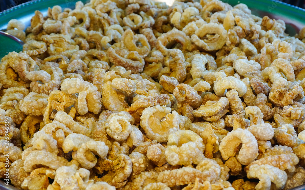 Fototapeta premium Deep fried or pork snack on tray at food market, pork rind, pork scratching ,pork crackling,snack meal,high cholesterol