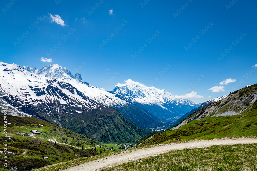 the mont blanc massif and the aguille du midi in the french alpine valley of chamonix showing clear blue skies and snow capped peaks during spring