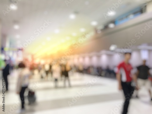 Blurred image abstract background of people or passenger walking in or hurry up in airport transport terminal and lounge interior from airplanes are walking to the immigration gates.
