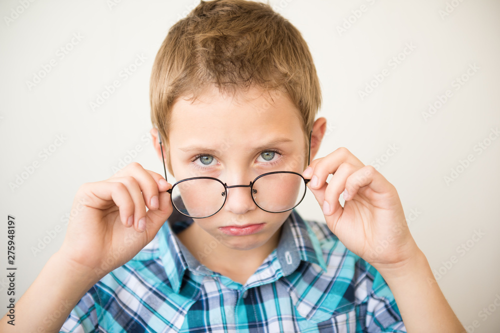 Handsome teen boy wears glasses. Poor vision and medicine concept