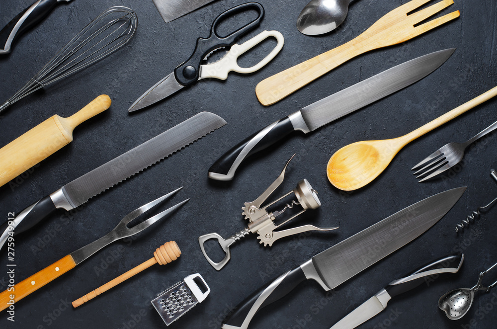 Fototapeta premium Wooden and metal kitchen utensils. Tools for cooking. Dark background. Flat lay