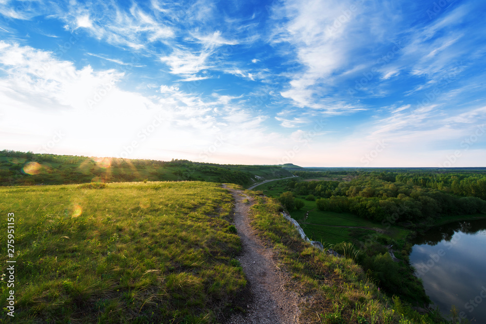 Obraz premium panorama of the river at sunset. the highlands, the sun's rays