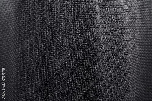 Close-up polyester fabric texture of black athletic shirt