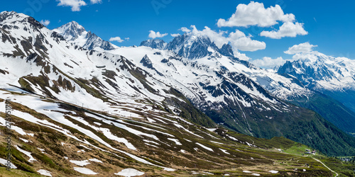 the mont blanc massif and the aguille du midi in the french alpine valley of chamonix showing clear blue skies and snow capped peaks during spring