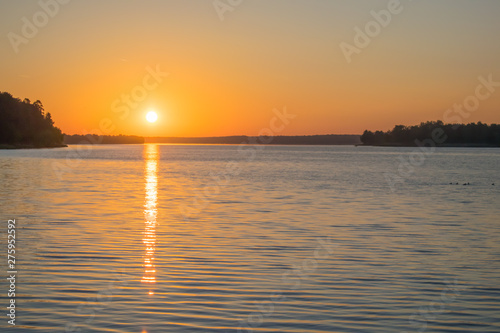 dawn of the red sun on the river