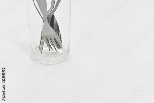 Spoon and fork placed in tumbler