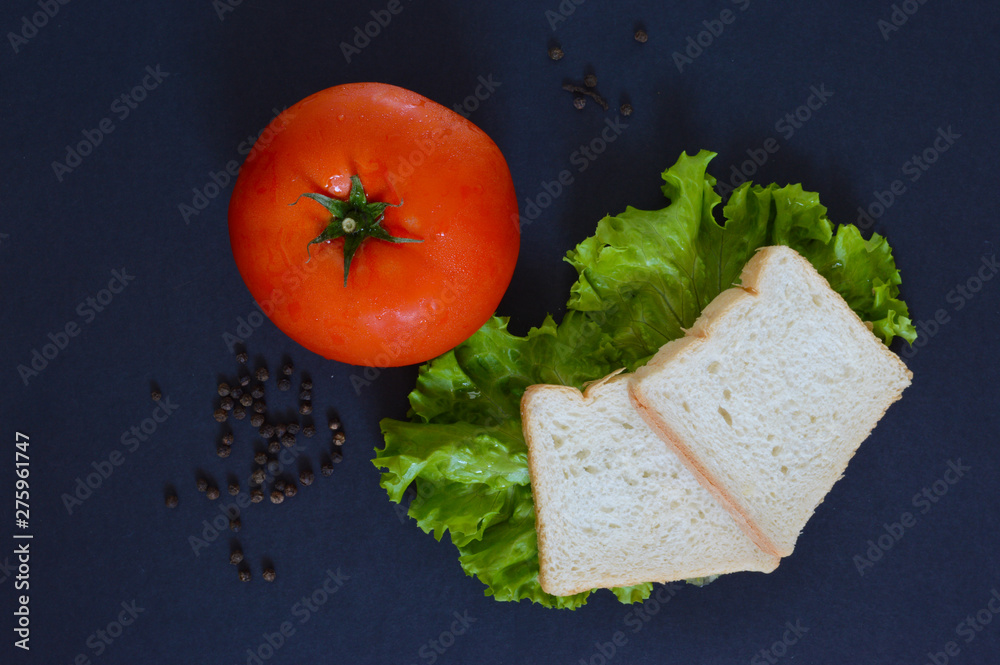 Fresh tomato and sandwich in the morning, allspice, salad and cheese.  Excellent background top view