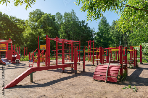 Wallpaper Mural Children playground on yard activities in public park surrounded by green trees at sunlight morning. Children run, slide, swing,seesaw on modern playground. Urban neighborhood childhood concept. Torontodigital.ca