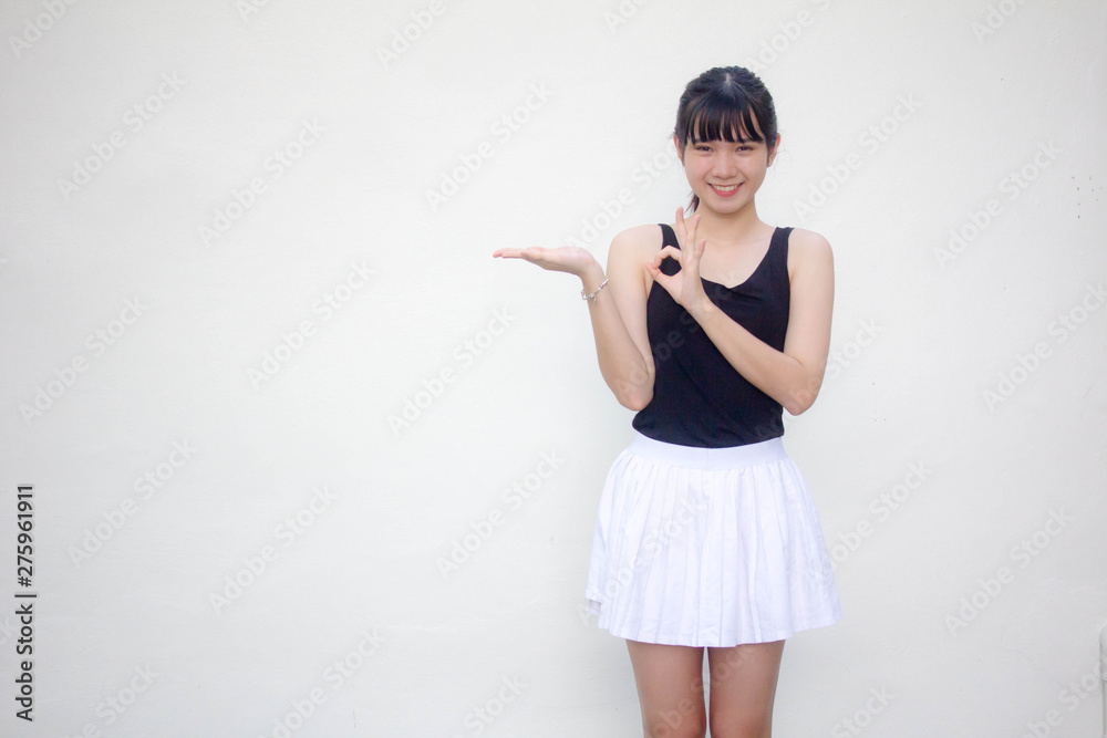 Portrait of thai adult beautiful girl black shirt white skirt show hand Portrait of thai adult beautiful girl black shirt white skirt show hand