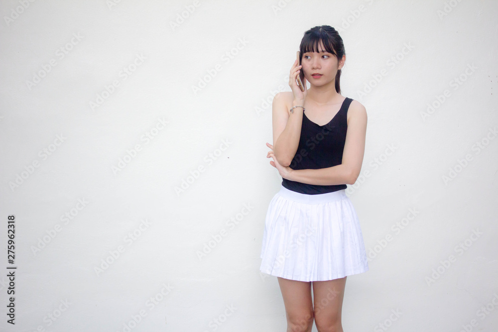 Portrait of thai adult beautiful girl black shirt white skirt calling smart phone Portrait of thai adult beautiful girl black shirt white skirt calling smart phone