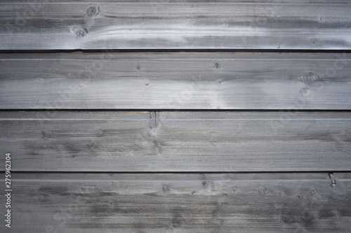 Old wooden surface of tightly nailed planks with cracks and knots. Grey background close-up. Selective focus. Copy space.