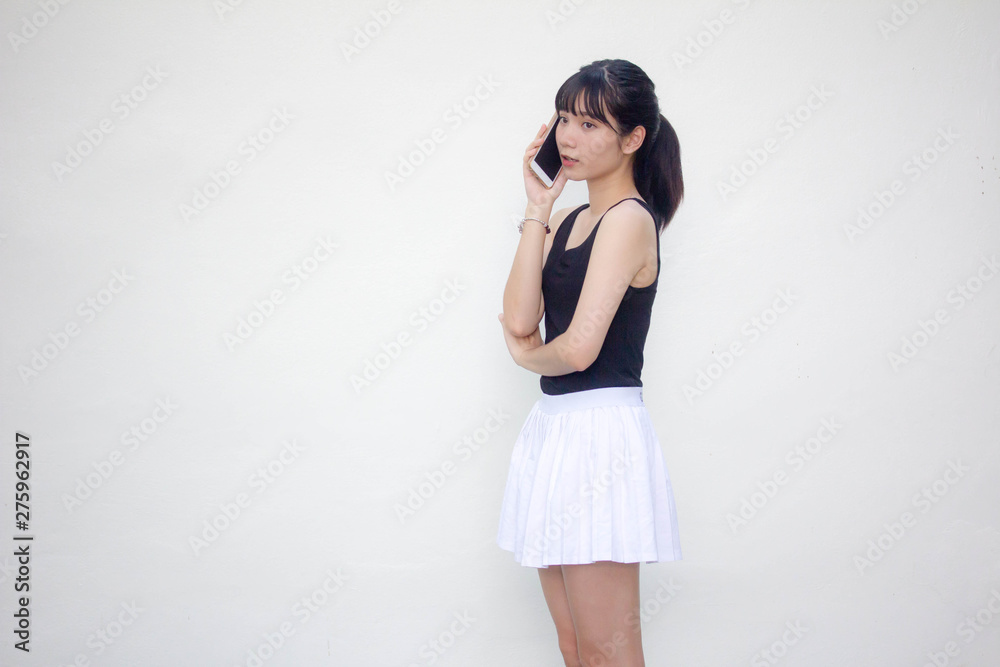 Portrait of thai adult beautiful girl black shirt white skirt calling smart phone Portrait of thai adult beautiful girl black shirt white skirt calling smart phone