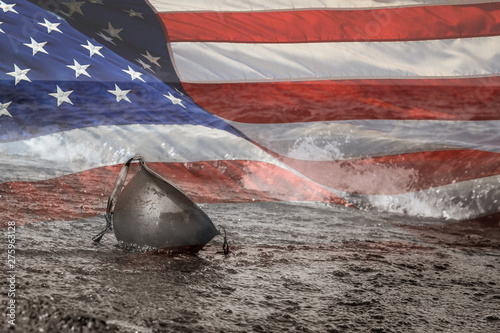 Wallpaper Mural United States Flag with Black and White photo of military helmet on beach in the water
