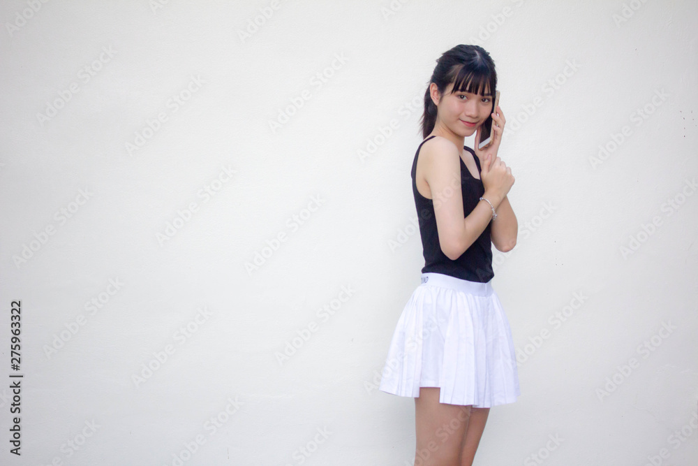 Portrait of thai adult beautiful girl black shirt white skirt calling smart phone Portrait of thai adult beautiful girl black shirt white skirt calling smart phone