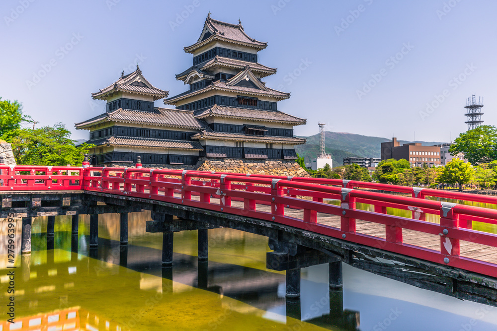 Matsumoto - May 25, 2019: The castle of Matsumoto and the red bridge leading to it, Japan Matsumoto - May 25, 2019: The castle of Matsumoto and the red bridge leading to it, Japan