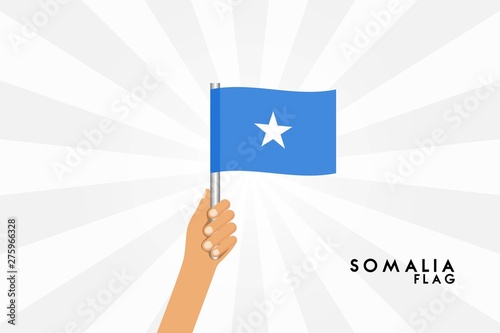 Vector cartoon illustration of human hands hold Somalia flag. Isolated object on white background. © stocktr