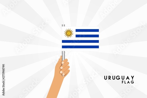 Vector cartoon illustration of human hands hold Uruguay flag. Isolated object on white background.