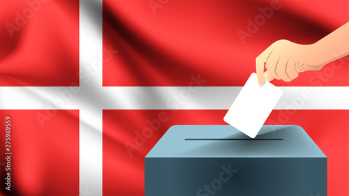 Male hand puts down a white sheet of paper with a mark as a symbol of a ballot paper against the background of the Denmark flag, Denmark the symbol of elections