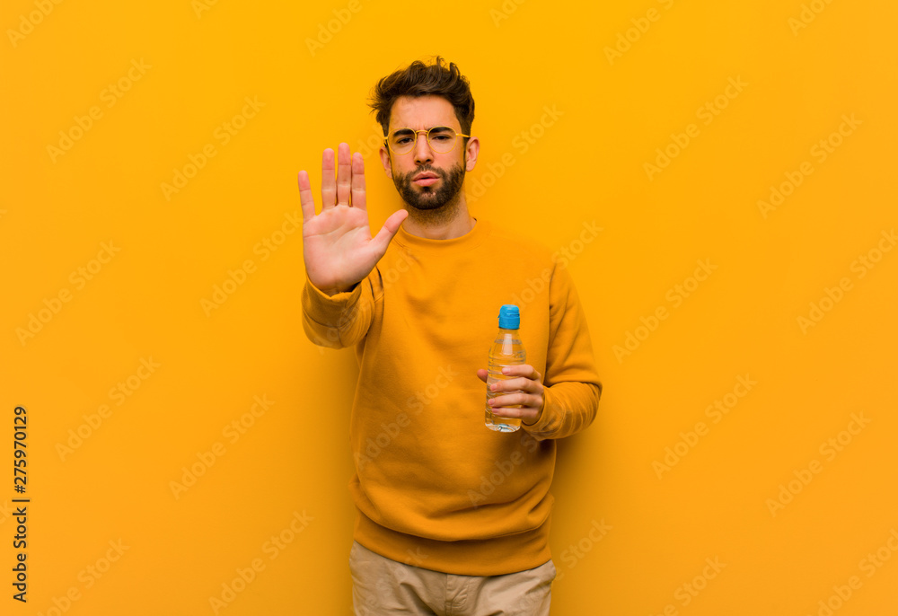 Young man putting hand in front Young man putting hand in front