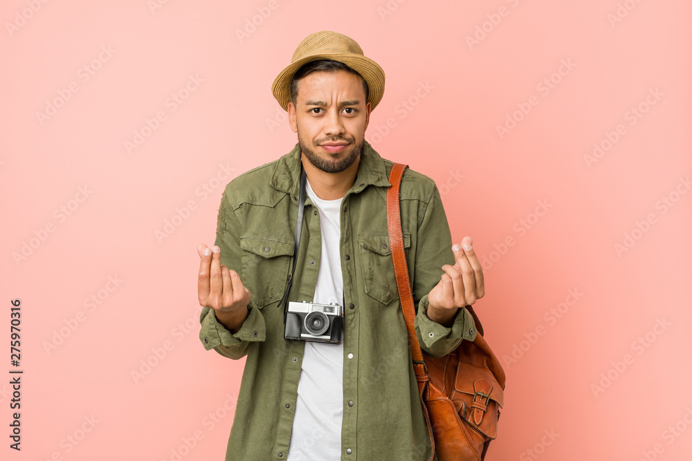 Young filipino traveler man showing that she has no money. Young filipino traveler man showing that she has no money.