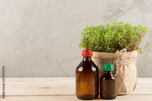 Alternative medicine concept - medicine in bottles and medicinal herbs on a wooden table