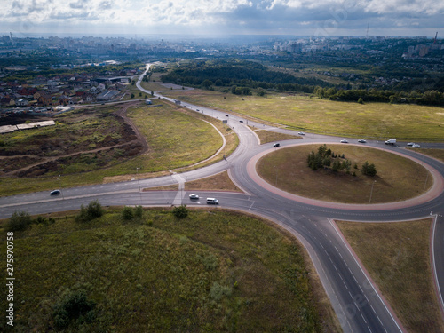 Top down aerial view of a traffic roundabout on a main road