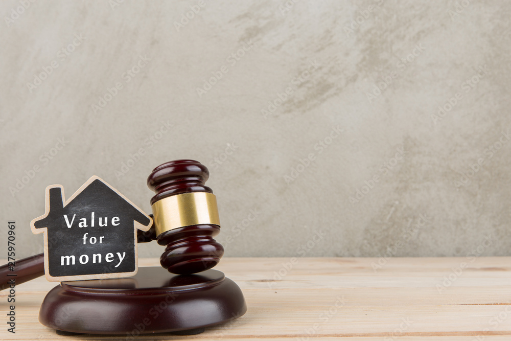 Real estate concept auction gavel and little house with inscription Value for money Real estate concept auction gavel and little house with inscription Value for money