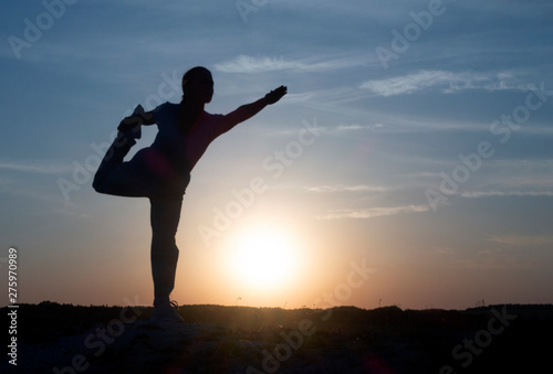 Yoga Silhouette meditation girl on the background of the sunset , fitness and healthy lifestyle.