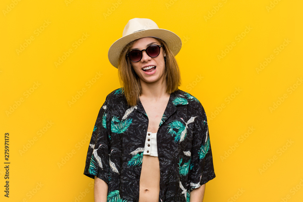 Young pretty woman wearing a hawaiian shirt very happy over yellow background. Young pretty woman wearing a hawaiian shirt very happy over yellow background.