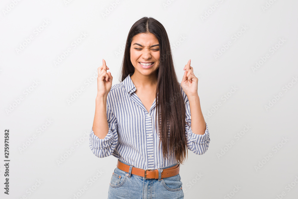 Young pretty arab woman crossing fingers for having luck Young pretty arab woman crossing fingers for having luck
