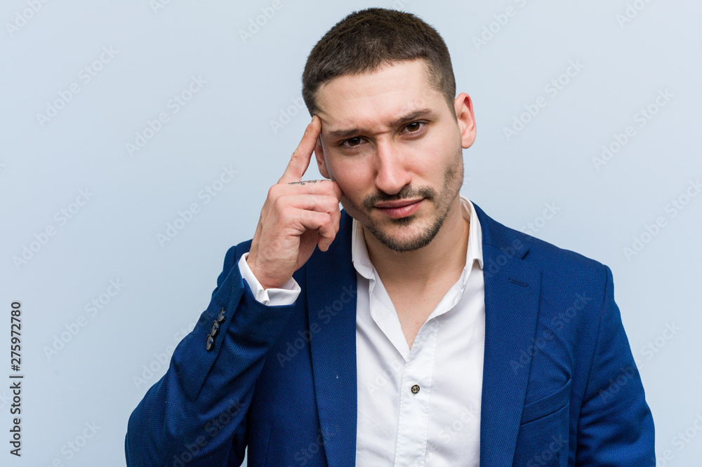 Young business caucasian man showing a disappointment gesture with forefinger. Young business caucasian man showing a disappointment gesture with forefinger.