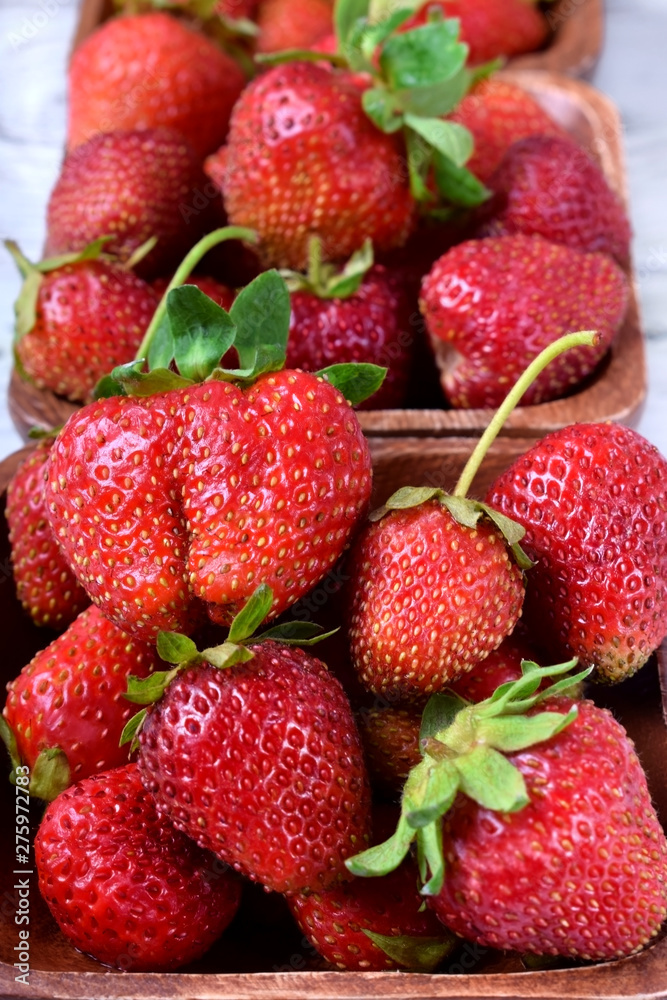 Fresh organic strawberries in little wooden bowls Fresh organic strawberries in little wooden bowls