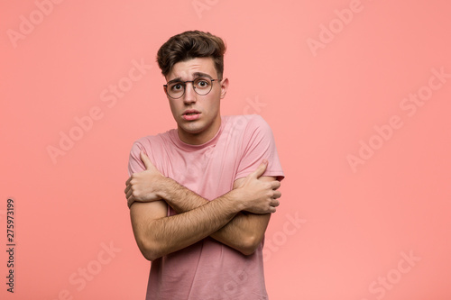 Fototapeta Young cool caucasian man going cold due to low temperature or a sickness