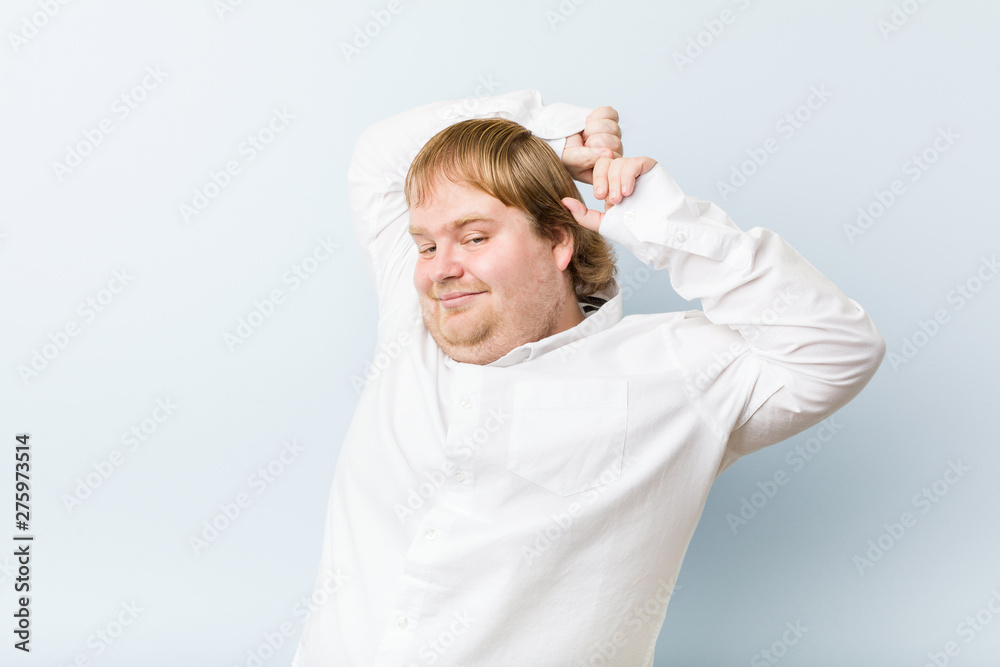 Young authentic redhead fat man stretching arms, relaxed position. Young authentic redhead fat man stretching arms, relaxed position.