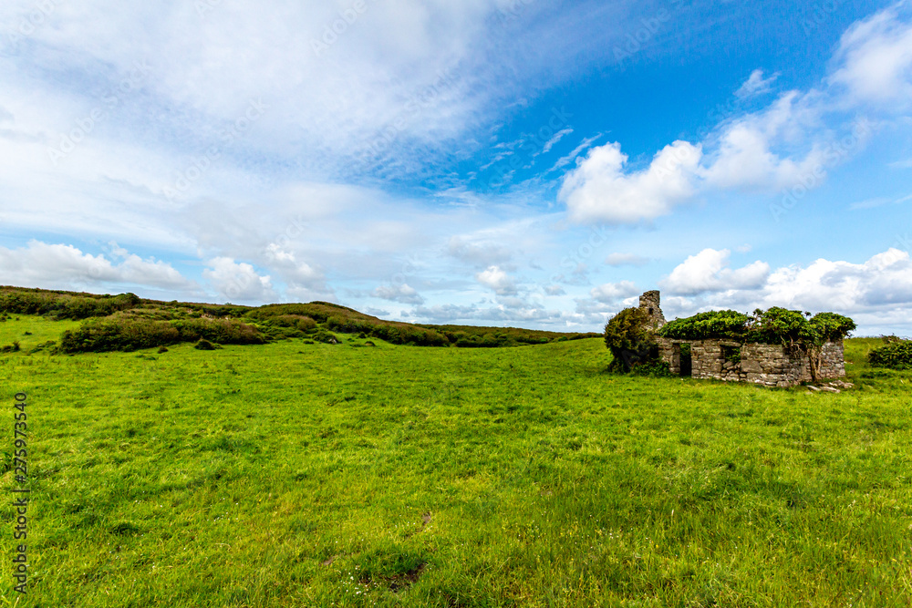 Beautiful landscape with a ruined house in the Burren, geosite and geopark, Wild Atlantic Way, wonderful sunny spring day in County Clare in Ireland