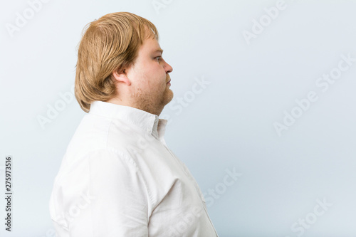 Young authentic redhead fat man gazing left, sideways pose.