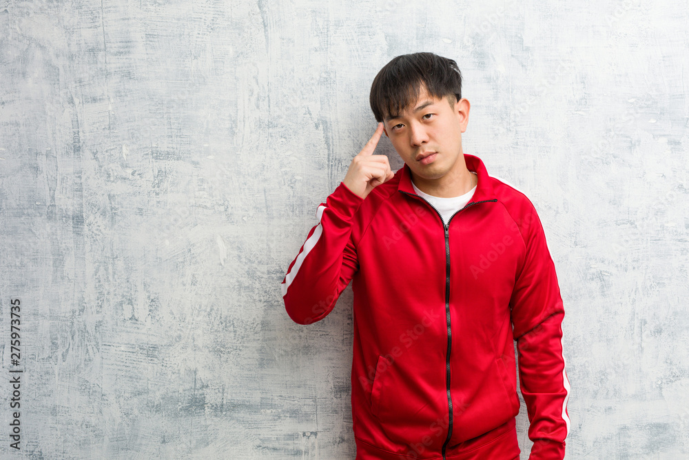 Young sport fitness chinese thinking about an idea Young sport fitness chinese thinking about an idea