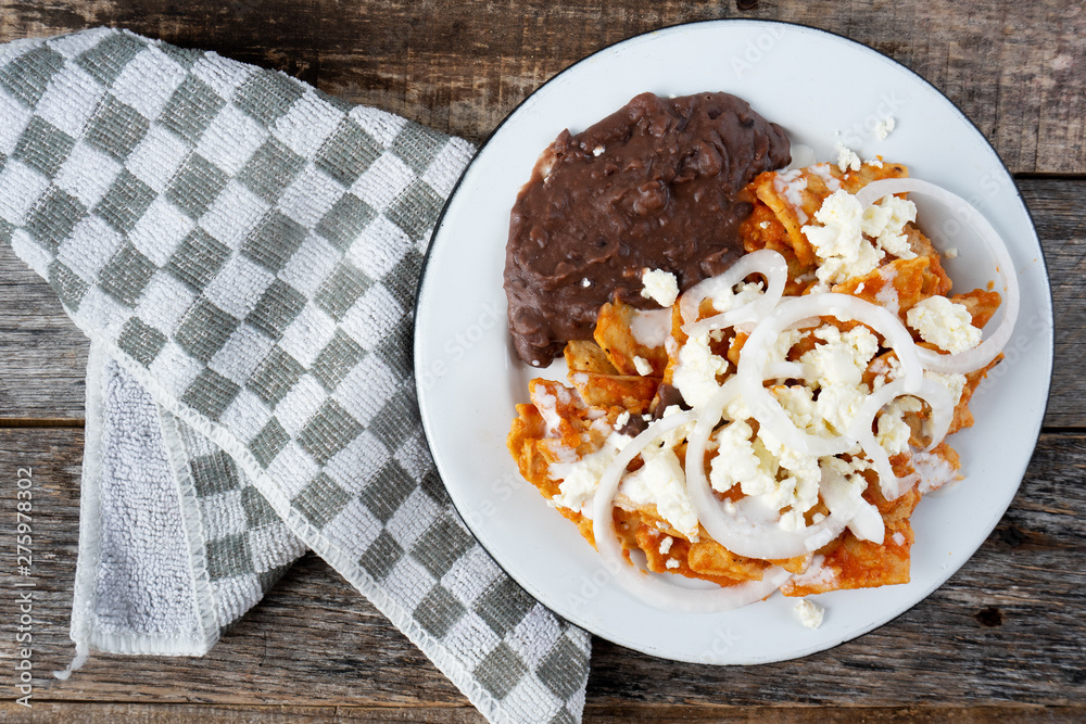 Mexican red chilaquiles with beans and cheese