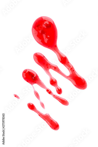 Cherry jam drizzle isolated on white background. Splashes of red berry jam. Top view.