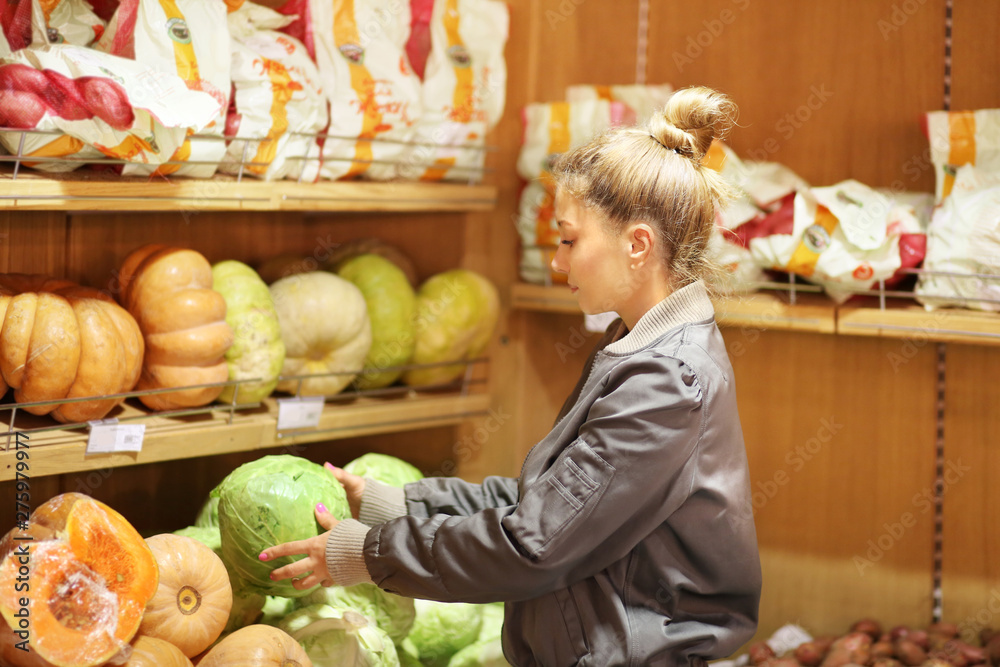 Fototapeta premium Woman buying vegetables at the market