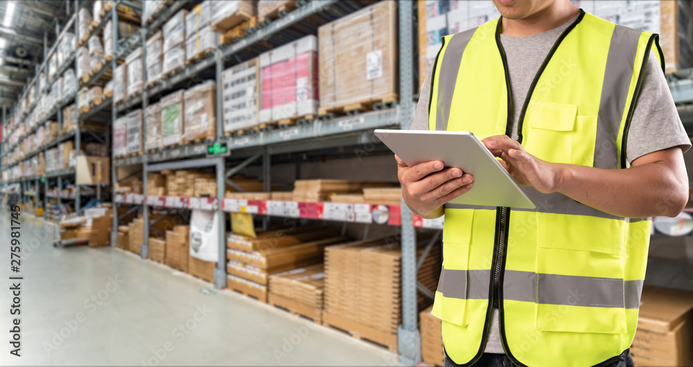 worker hand holding pad for check order pick time in smart factory warehouse worker hand holding pad for check order pick time in smart factory warehouse