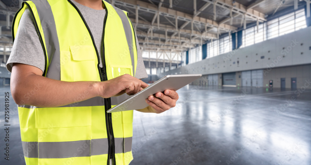 worker hand holding pad for check order pick time in empty warehouse worker hand holding pad for check order pick time in empty warehouse